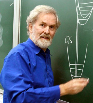 Professor Reimers drawing scientific calculations on a blackboard