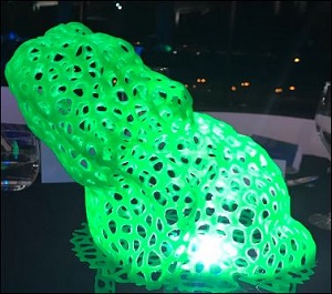 Green web-like plastic cane toad lit from inside