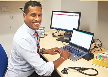 Man seated in front of a computer