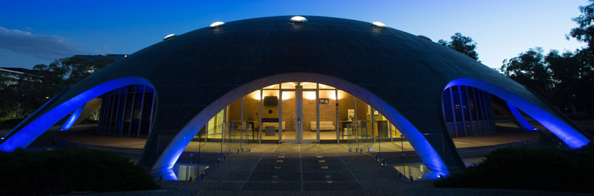 The Shine Dome at night with blue light on the arches