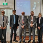 Group of people standing in front of screen