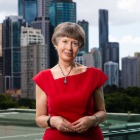 Woman standing on a balcony in a red dress