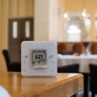 An air quality monitor on a table displays the reading of 621 ppm