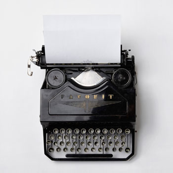 Old style manual typewriter with blank paper inserted