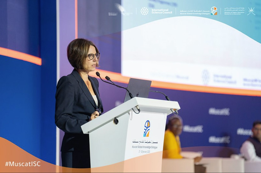 Woman speaking at lectern on a large stage