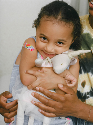 Happy young girl cuddling a toy