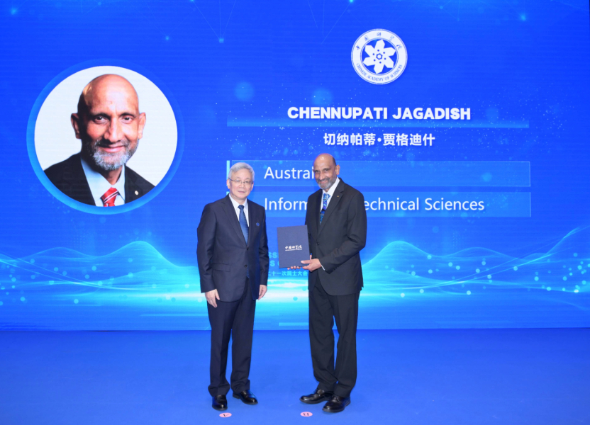 Two men dressed in suits on stage